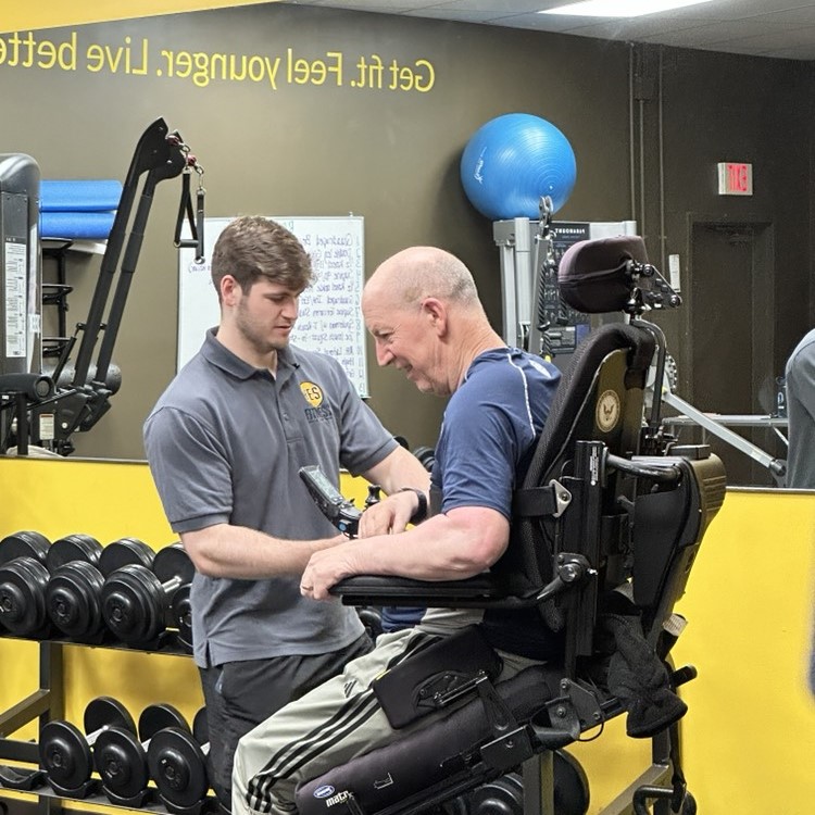 Coach working with wheelchair client at YES Fitness